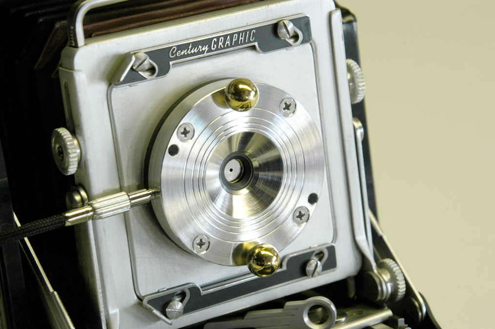 Christiansen's Apo II shutter is made from titanium, brass, and Garolite, and is cable-release activated. Pinholes and zoneplates of varying dimension may be swapped in and out depending on focal length.